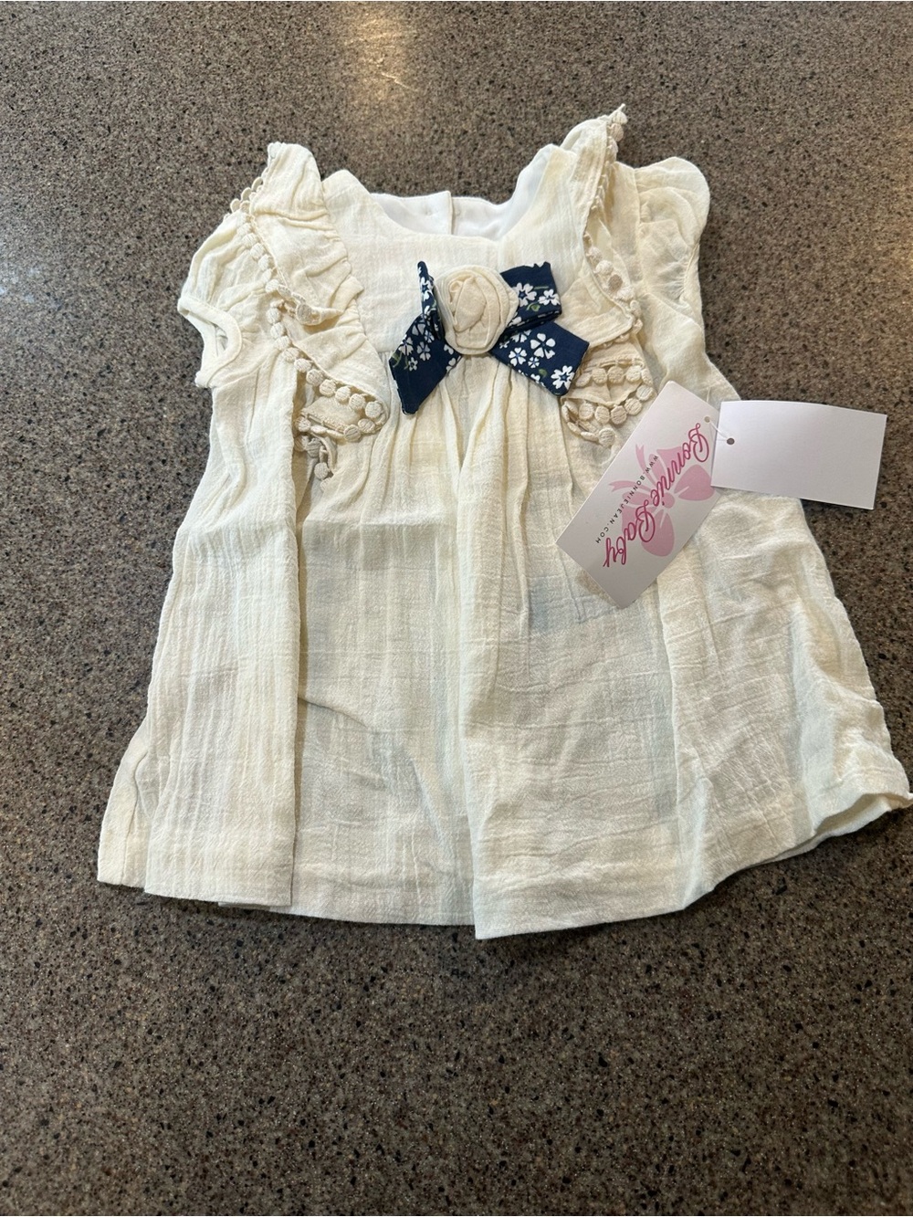 Cream Ruffle Girls' dress with Navy Floral Bow